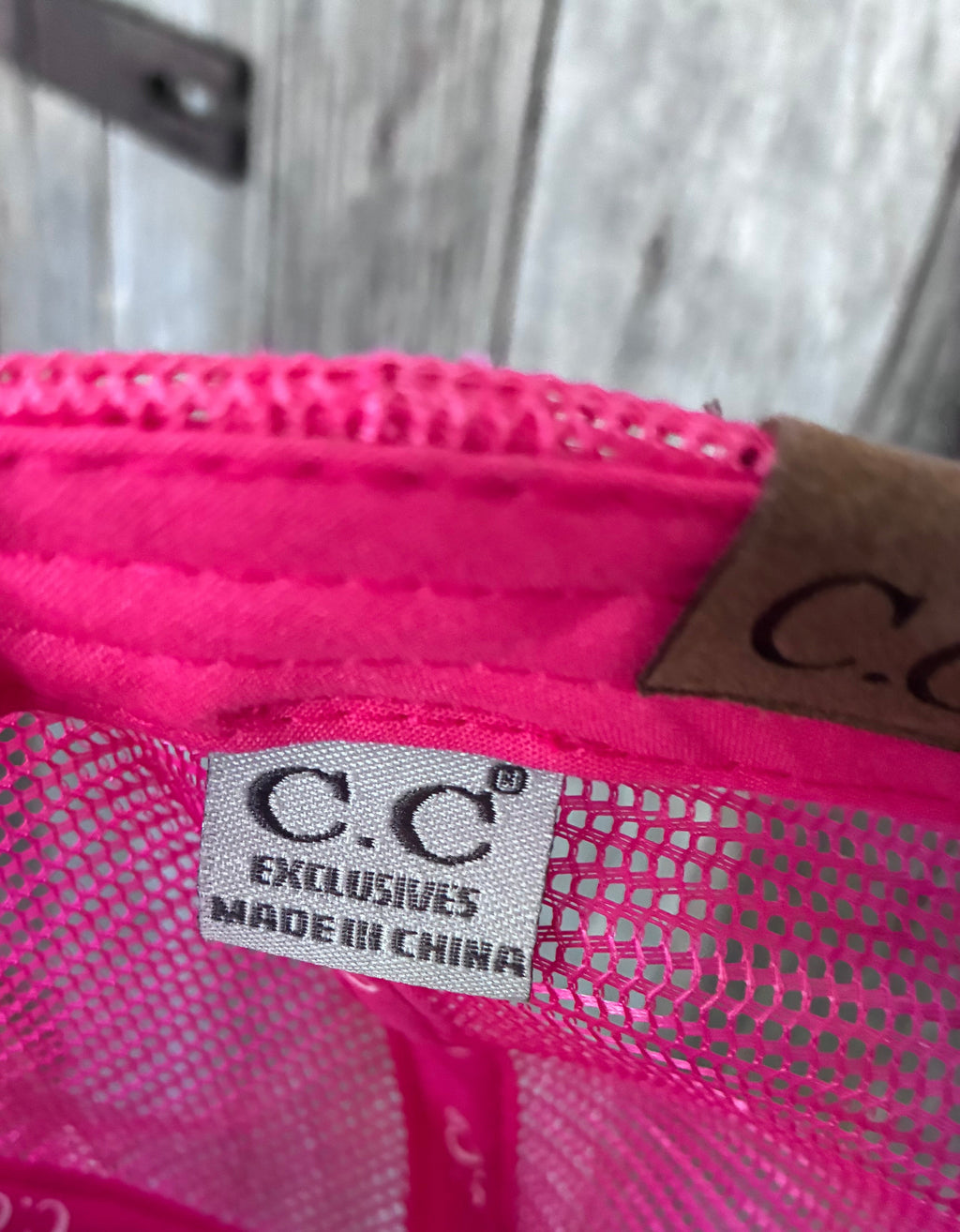 Gold chain brim detail on pink and white trucker cap