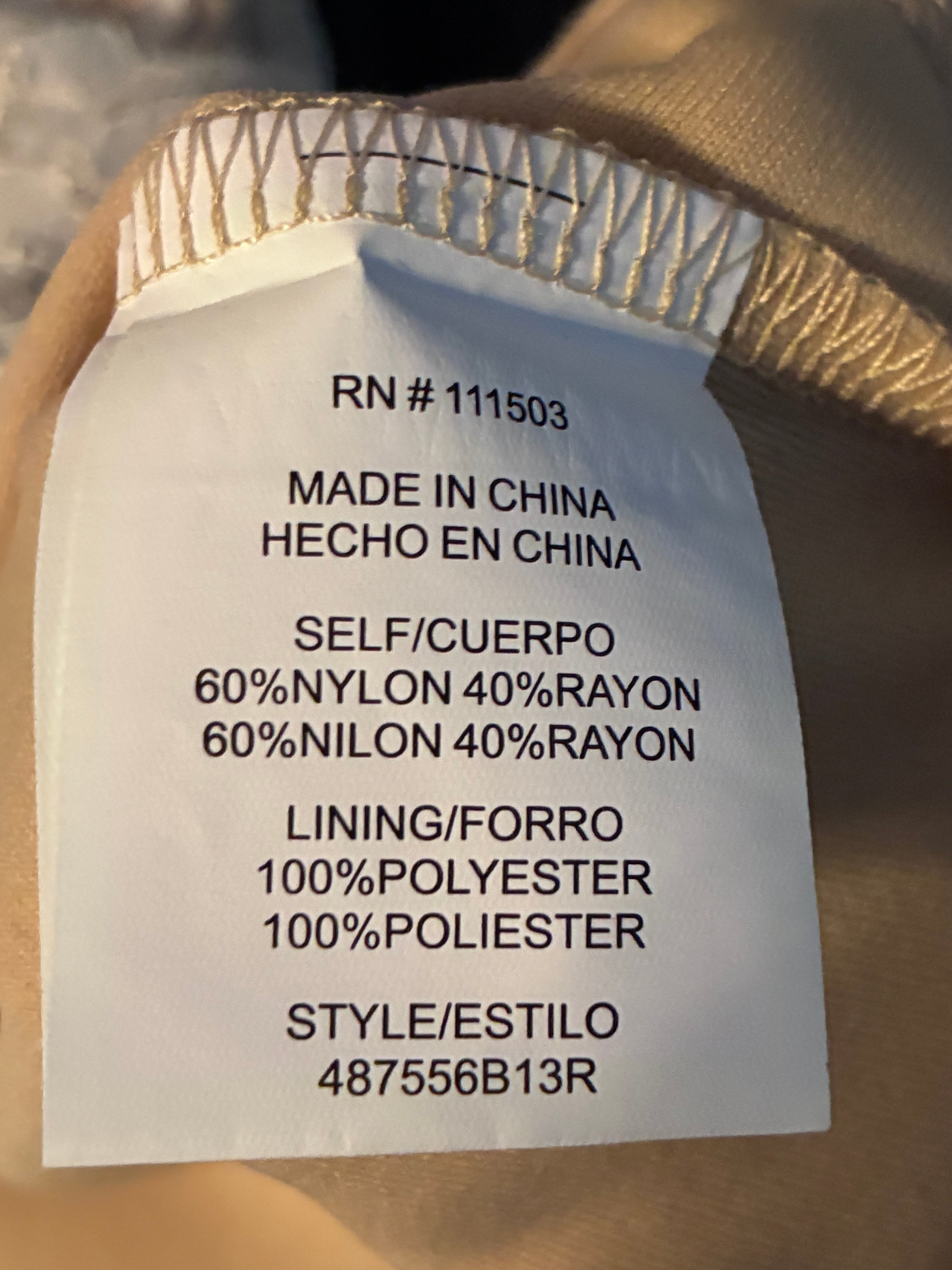 Care tag showing turn inside out, machine wash cold gentle, lay flat to dry, iron low no steam